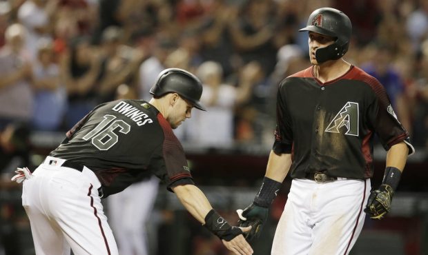 Arizona Diamondbacks Nick Ahmed celebrates with Chris Owings (16) after hitting a three-run home ru...