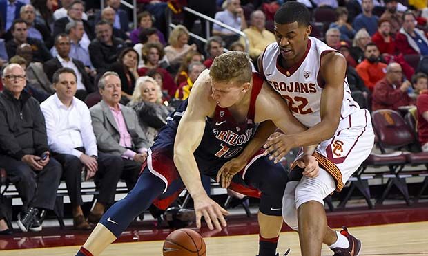 Arizona forward Lauri Markkanen (10) and Southern California guard De'Anthony Melton (22) vie for a...