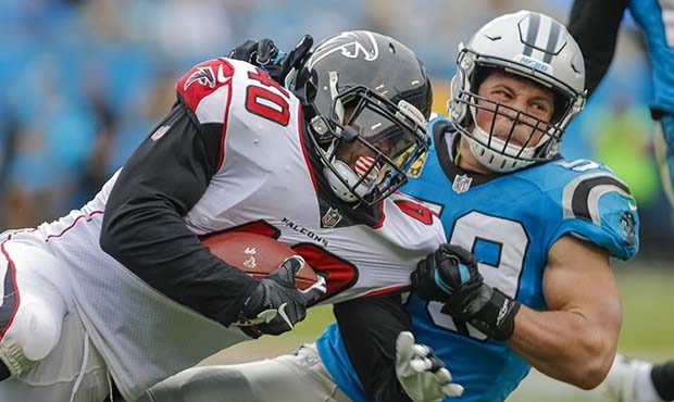 Atlanta Falcons' Derrick Coleman (40) controls the football as he is taken down by Carolina Panther...
