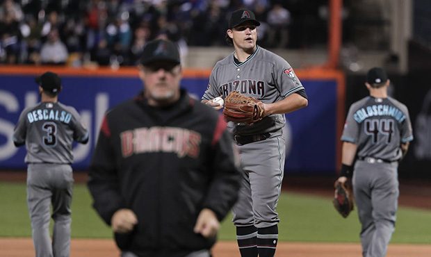 Arizona Diamondbacks pitcher Zack Godley, center right, pauses after a conference on the mound duri...