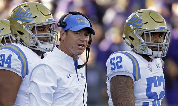 UCLA head coach Jim Mora looks toward the field against Washington in the first half of an NCAA col...