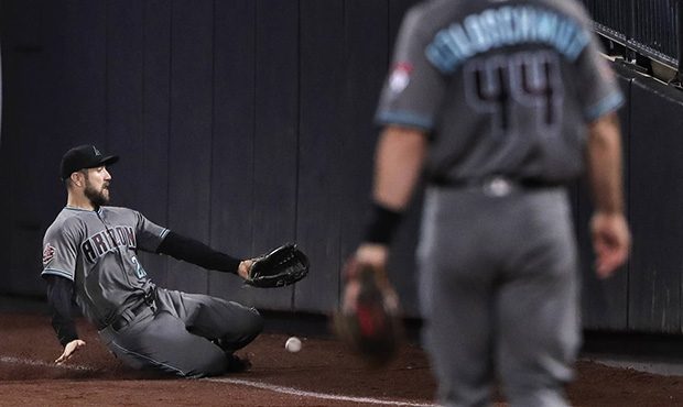 Arizona Diamondbacks right fielder Steven Souza Jr., left, cannot catch up with a pop foul ball hit...