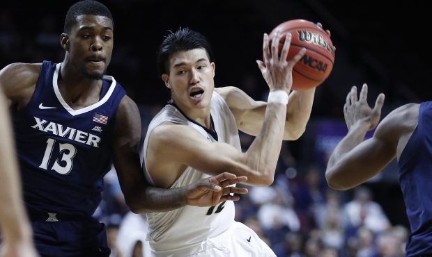 George Washington's Yuta Watanabe drives around Xavier's Naji Marshall (13) during the second half ...