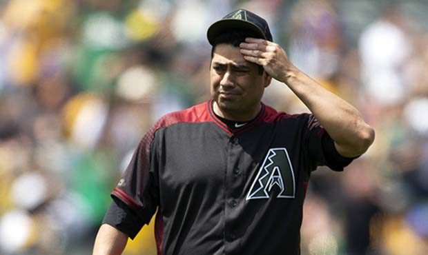 Arizona Diamondbacks pitcher Jorge De La Rosa reacts after giving up a solo home to Oakland Athleti...