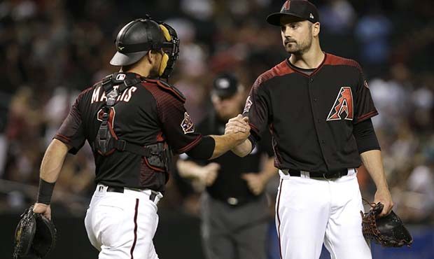 Arizona Diamondbacks pitcher T.J. McFarland and Jeff Mathis (2) celebrate after the Diamondbacks de...