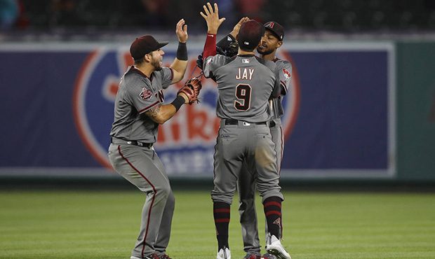 Arizona Diamondbacks' David Peralta, from left, Jon Jay and Jarrod Dyson celebrate the team's 7-4 w...