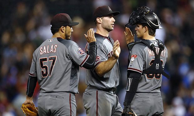 Arizona Diamondbacks first baseman Paul Goldschmidt, center, is congratulated by relief pitcher Fer...