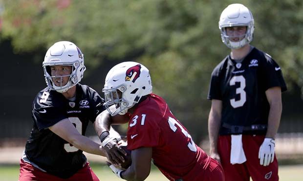Arizona Cardinals' Sam Bradford (9) hands off to David Johnson (31) during an organized team activi...