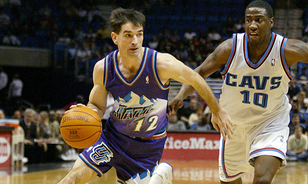 Utah Jazz guard John Stockton (12) drives around Cleveland Cavaliers guard Milt Palacio during the ...