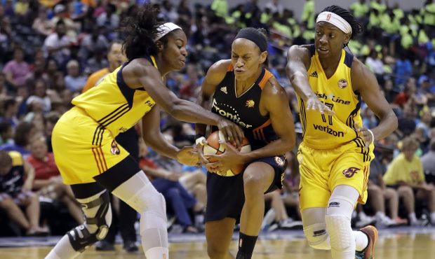Connecticut Sun's Jasmine Thomas (5) goes to the basket against Indiana Fever's Devereaux Peters (1...