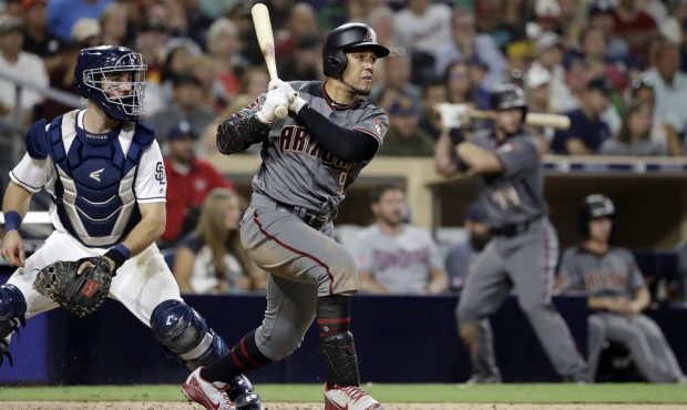 Arizona Diamondbacks' Jon Jay watches his two-run double next to San Diego Padres catcher Austin He...