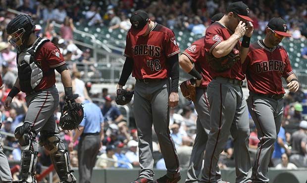 Arizona Diamondbacks starting pitcher Patrick Corbin, center, is visited on the mound after allowin...