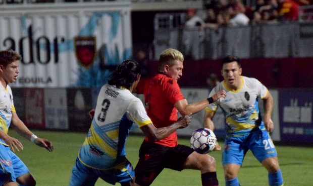 Phoenix Rising midfielder Evan Waldrep blasts past several Las Vegas defenders. Prior to Phoeinix R...