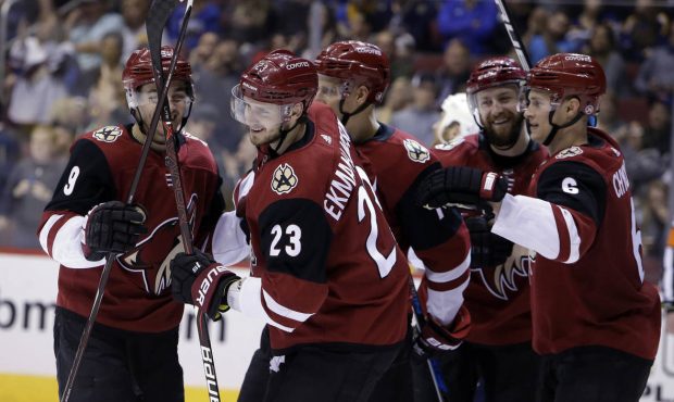 Arizona Coyotes defenseman Oliver Ekman-Larsson (23) celebrates with teammates after scoring in the...
