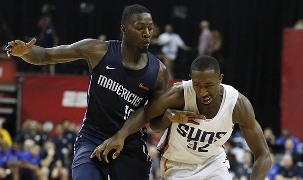 Phoenix Suns' Davon Reed drives around Dallas Mavericks' Dorian Finney-Smith during the second half...