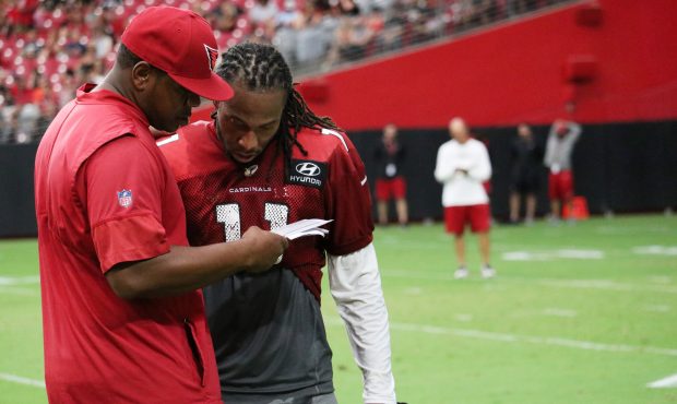 Larry Fitzgerald talks to Cardinals quarterbacks coach Byron Leftwich on Saturday, July 28, 2018, t...