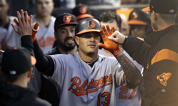 Baltimore Orioles' Manny Machado (13) celebrates in the dugout his home run off Chicago White Sox's...
