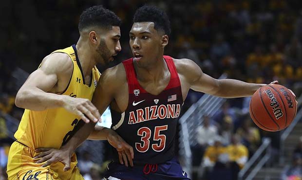 Arizona's Allonzo Trier (35) drives the ball against California's Nick Hamilton, left, in the secon...