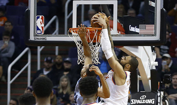 Phoenix Suns center Tyson Chandler, right, dunks the winning shot against Memphis Grizzlies forward...