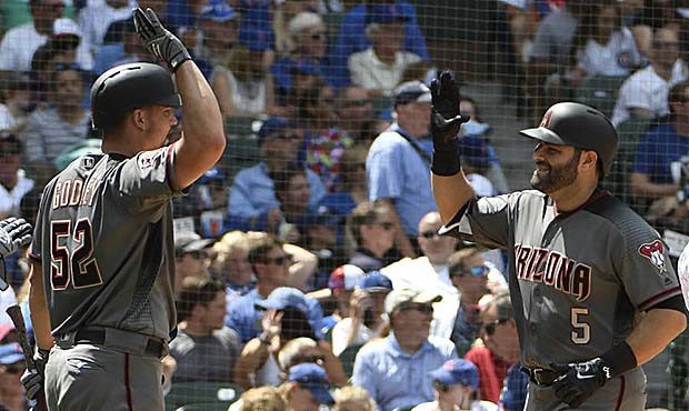 Arizona Diamondbacks' Alex Avila (5) is greeted by Zack Godley (52) after hitting a two-run home ru...