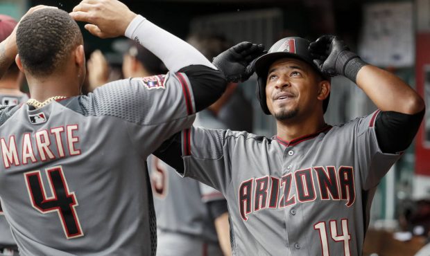 Arizona Diamondbacks' Eduardo Escobar (14) celebrates with Ketel Marte (4) in the dugout after hitt...