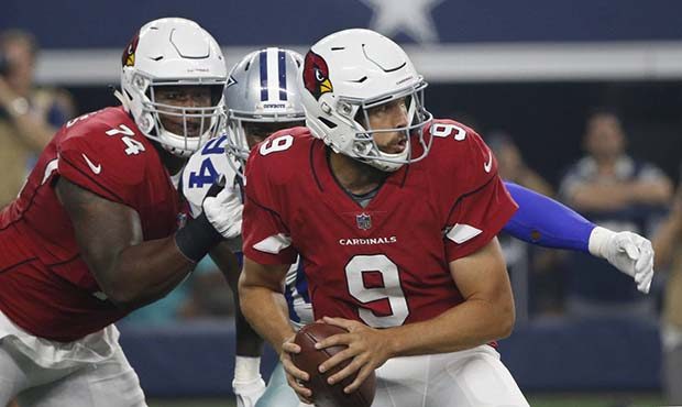 Arizona Cardinals quarterback Sam Bradford (9) ducks as Dallas Cowboys defensive end Randy Gregory ...