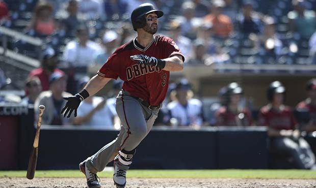 Arizona Diamondbacks Daniel Descalso watches his home run during the eighth inning of a baseball ga...