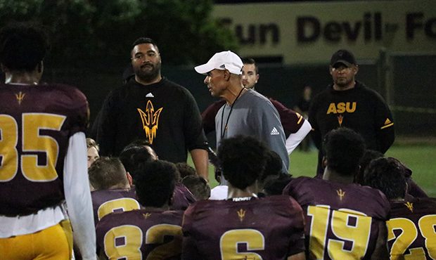 ASU head coach Herm Edwards talks with his players after the team’s first scrimmage of the season...