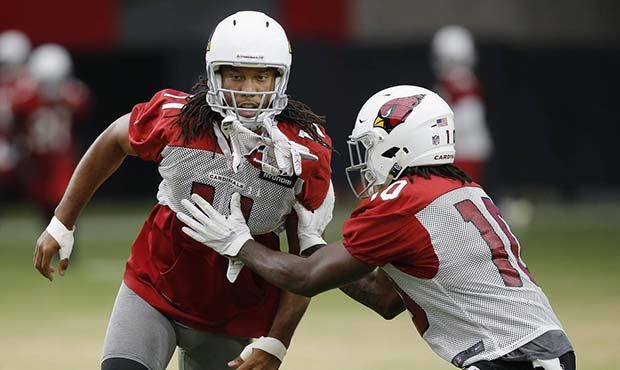 Arizona Cardinals wide receiver Larry Fitzgerald (11) tries to shed a block from wide receiver Chad...