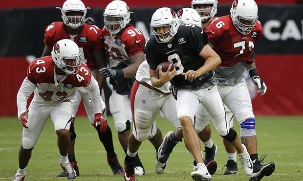 Arizona Cardinals quarterback Sam Bradford (9) runs with the ball as he gets past linebacker Haason...