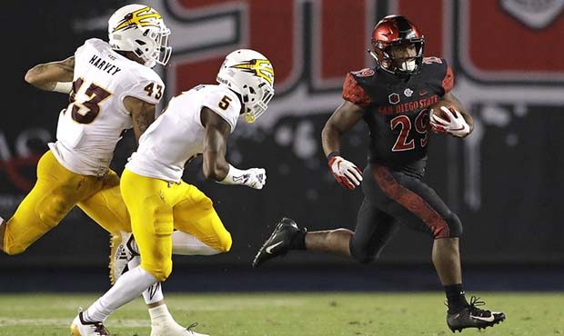 San Diego State running back Juwan Washington, right, runs with the ball as Arizona State safety Ja...