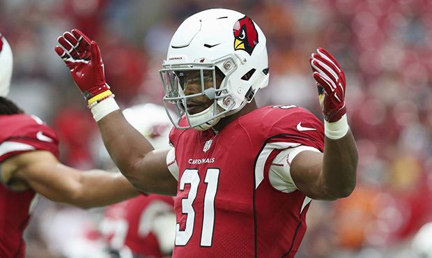 Arizona Cardinals running back David Johnson stretches out with teammates prior to an NFL football ...