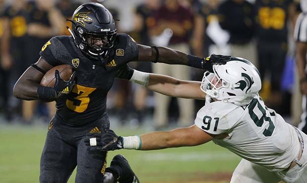 Arizona State running back Eno Benjamin (3) gives Michigan State defensive end Jack Camper (91) a s...
