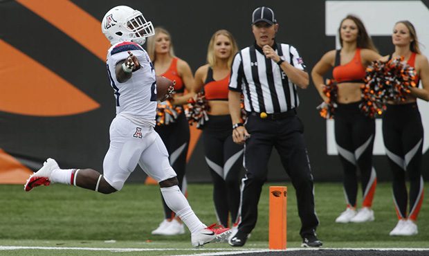 Arizona running back J.J. Taylor, celebrates as he crosses the goal line on a 40 yard touchdown run...