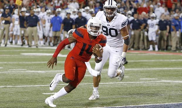 Arizona quarterback Khalil Tate (14) scores a touchdown against Brigham Young in the second half du...