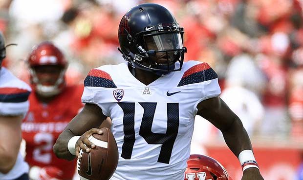 Arizona quarterback Khalil Tate (14) escapes the tackle of Houston defensive tackle Ed Oliver durin...
