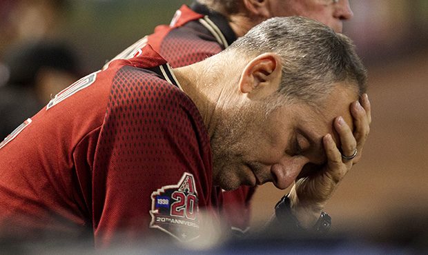 Arizona Diamondbacks manager Torey Lovullo wipes his brow during a baseball game against the Colora...