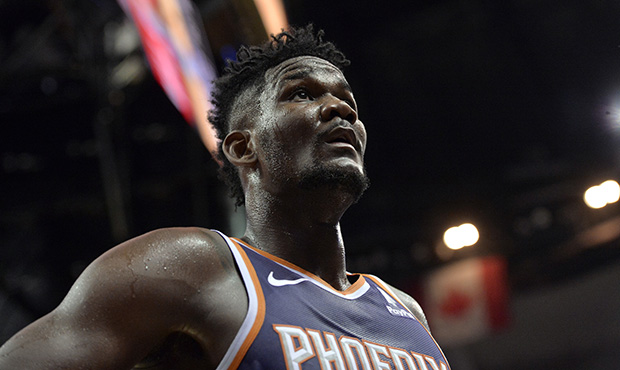 Phoenix Suns center Deandre Ayton walks off of the court after the first half of an NBA basketball ...
