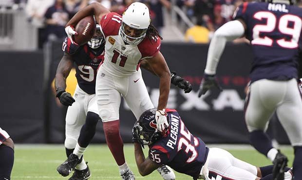 Arizona Cardinals wide receiver Larry Fitzgerald (11) is hits by Houston Texans defensive back Eddi...