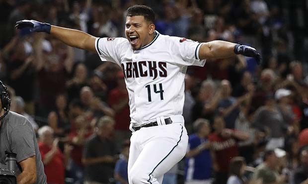Arizona Diamondbacks' Eduardo Escobar celebrates as he rounds the bases after hitting a walk-off ho...