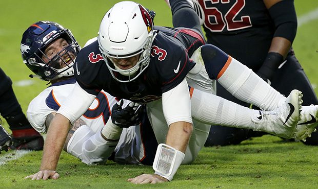 Arizona Cardinals quarterback Josh Rosen (3) his hit after the throw against the Denver Broncos dur...