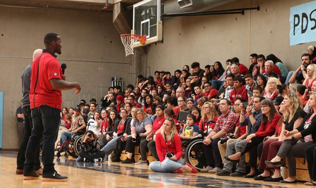 Derrick Coleman speaks to the crowd at the Phoenix Day School for the Deaf, next to an interpreter ...