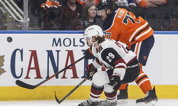 Arizona Coyotes ' Mario Kempe (29) and Edmonton Oilers' Oscar Klefbom (77) vie for the puck during ...