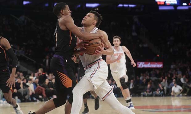 Phoenix Suns' De'Anthony Melton, center left, defends against New York Knicks' Kevin Knox (20) duri...