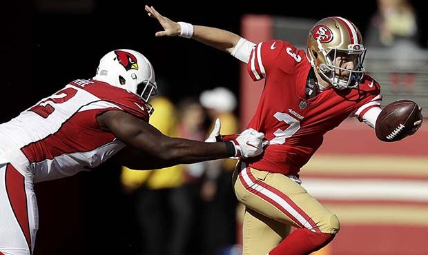 San Francisco 49ers quarterback C.J. Beathard, right, runs from Arizona Cardinals defensive tackle ...