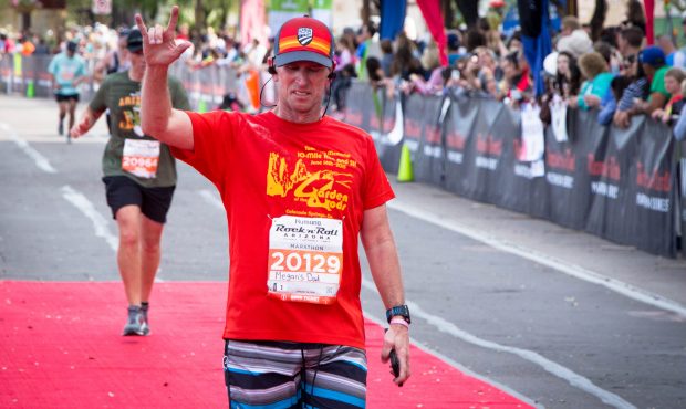 Neal Oseland, running across the finish line with the words "Megan's Dad" on his bib, was motivated...