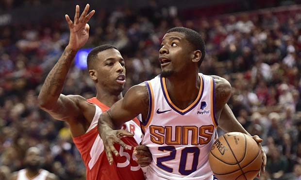 Phoenix Suns forward Josh Jackson (20) controls the ball as Toronto Raptors guard Delon Wright (55)...