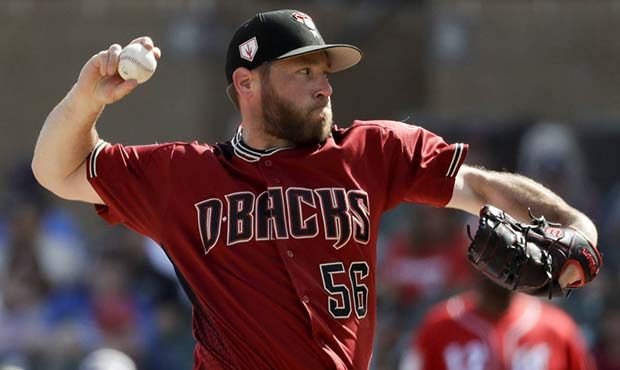 Arizona Diamondbacks relief pitcher Greg Holland throws against the Cincinnati Reds during the four...