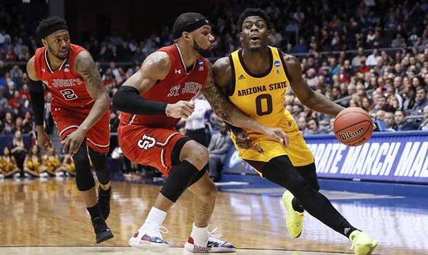 Arizona State's Luguentz Dort (0) drives against St. John's Marvin Clark II, center, during the fir...