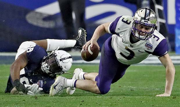 Washington quarterback Jake Browning (3) is tripped up by Penn State defensive end Shareef Miller (...